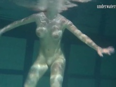 KiloMatures presents: Naked brunette with big tits swims solo