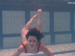 KiloMatures presents: Swimming brunette in one piece swimsuit