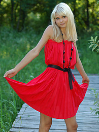 KiloMatures presents: Naughty teen appears in her sexy red dress and starts removing it passionately and moving slowly.